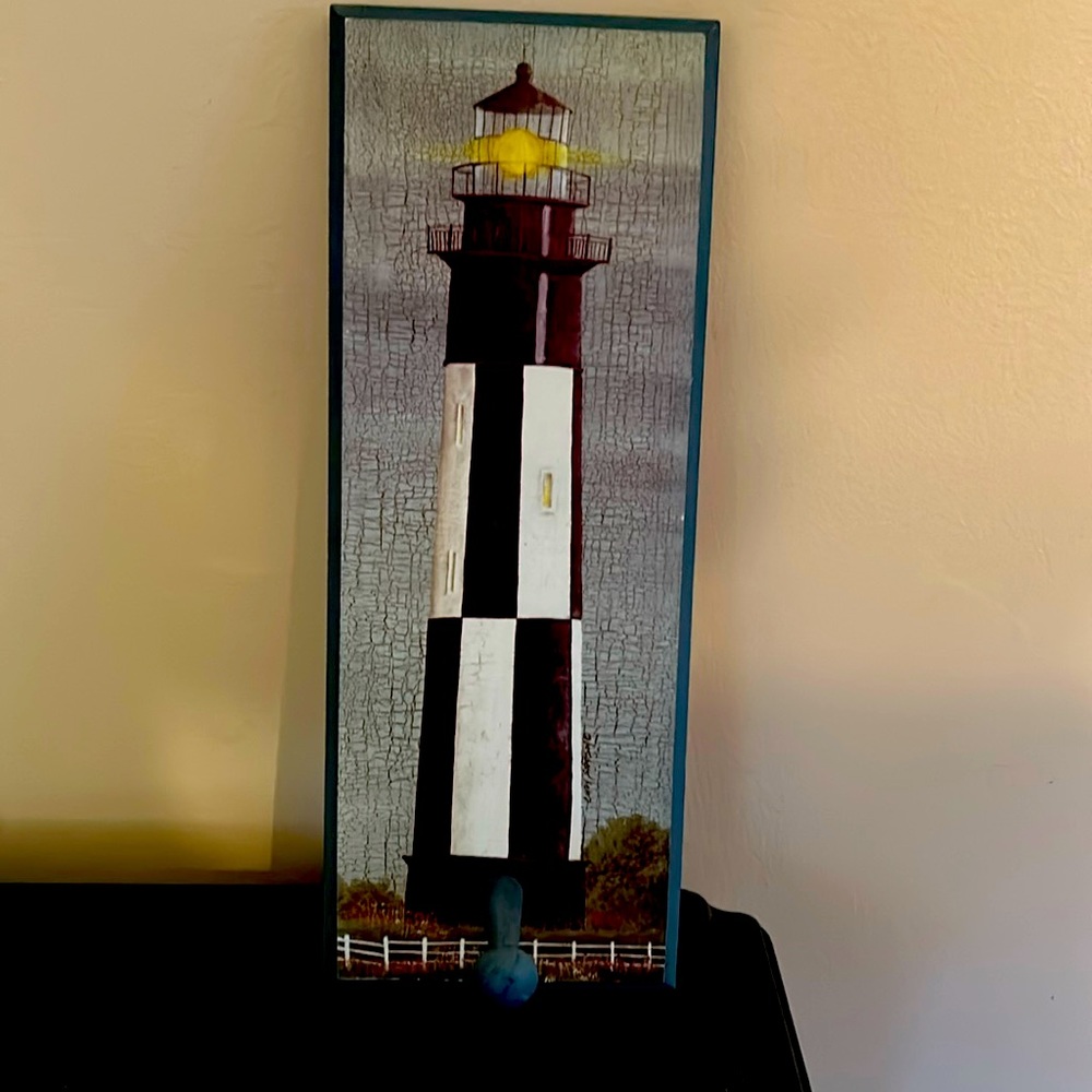 Wooden painted decorative lighthouse plaque with post.